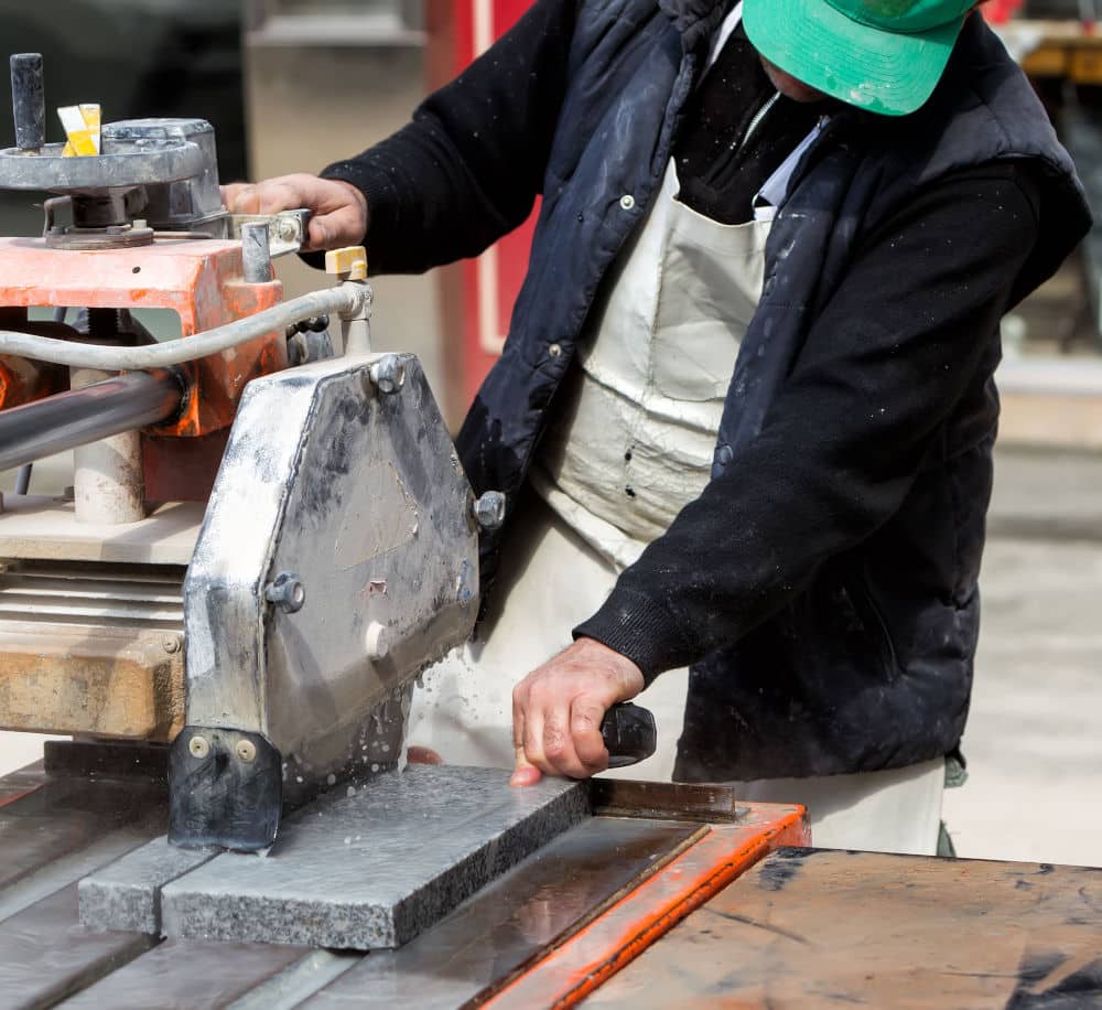 Workers are working, cutting marble cutter